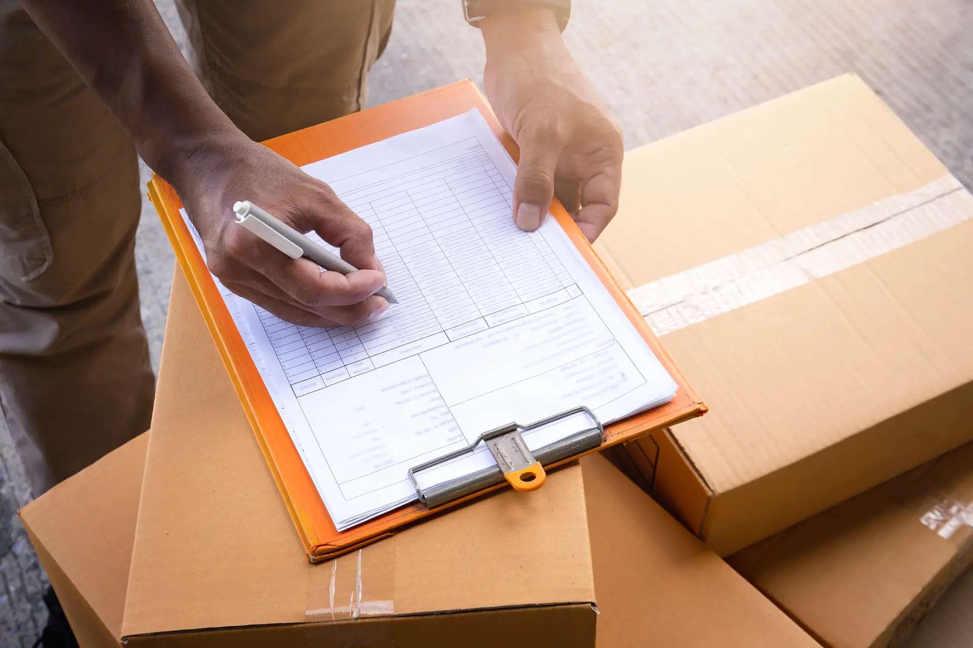 hand writing on clipboard on boxes
