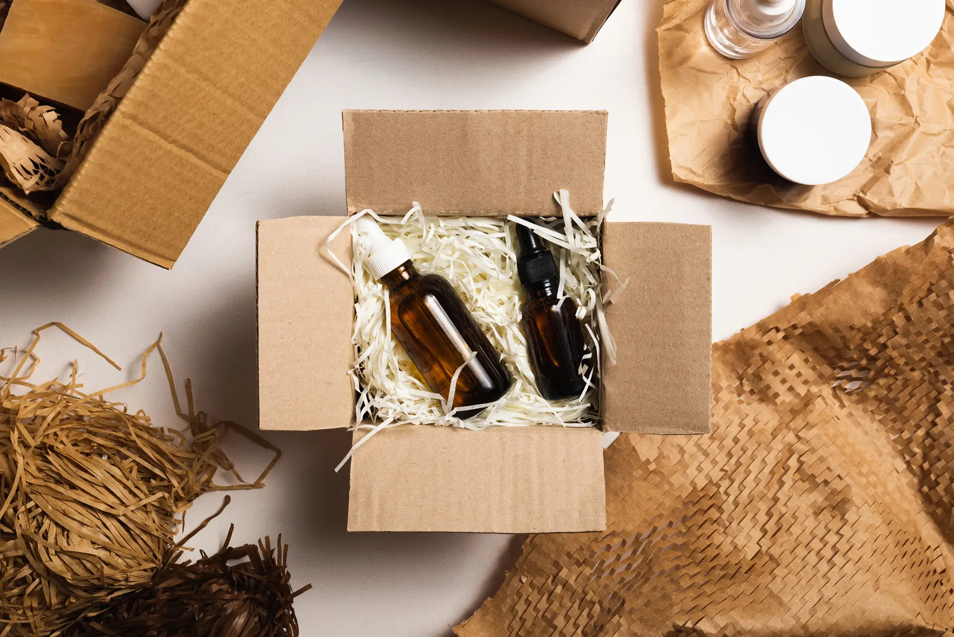 bottles packed in straw in a box surrounded by packaging materials